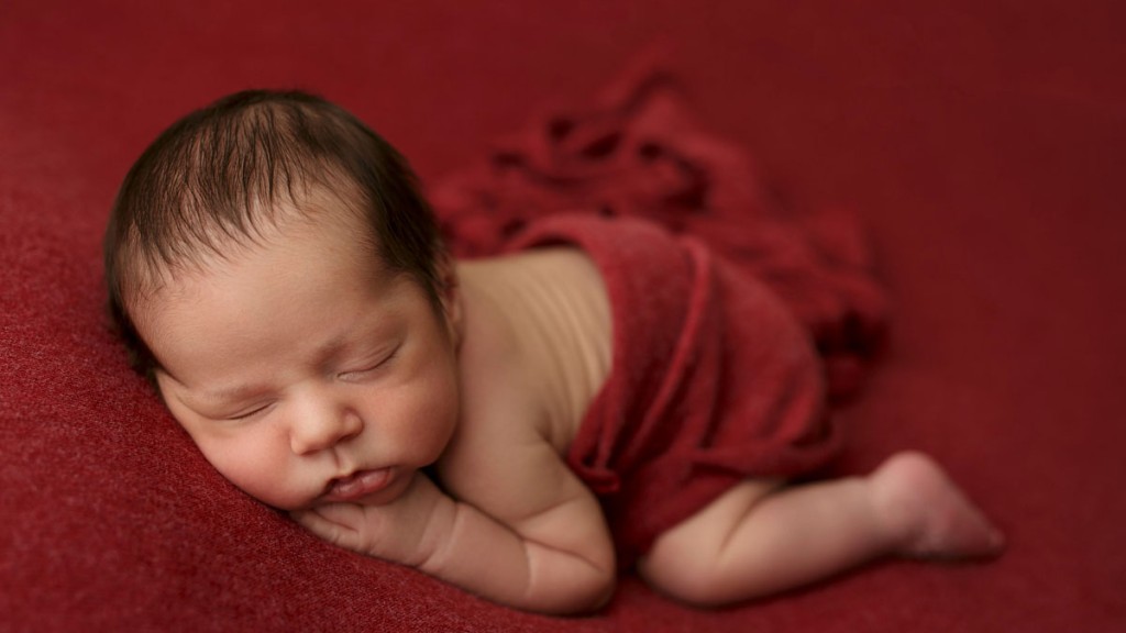 Squishy baby boy on a beautiful red fabric backdrop. Taken in my San Marcos, Ca portrait studio.