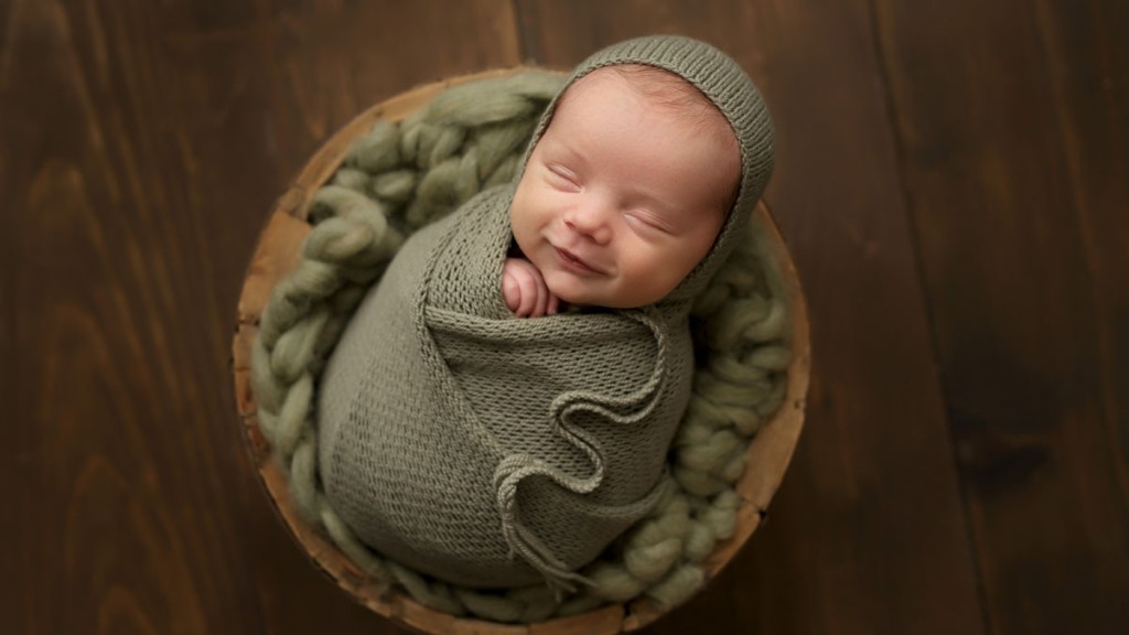 Swaddled in olive green, this little guy is content and happy. Posed in a wooden bowl by a San Marcos, ca newborn photographer.