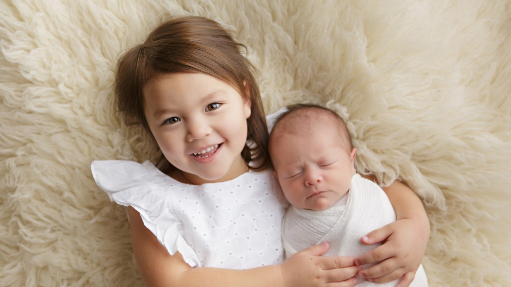 Shelly Rosen is worth the drive to San Marcos to get poses like this sweet sibling pose on furry cream flokati made in her San Marcos, ca newborn photography studio.